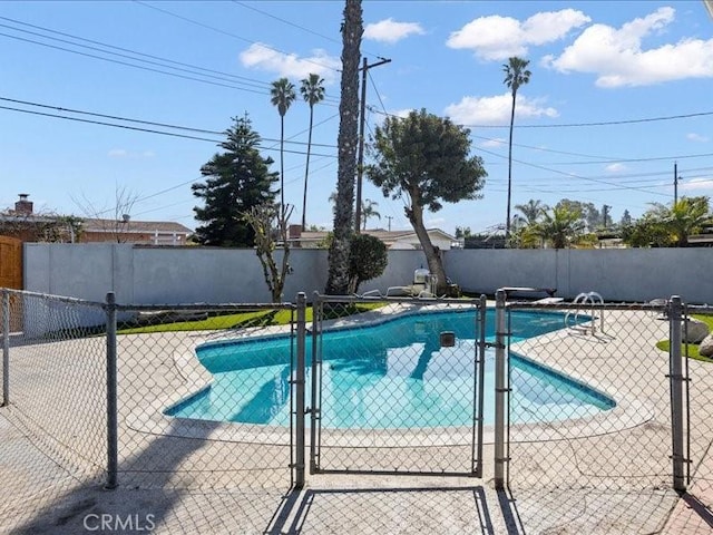 view of swimming pool with a patio, fence, and a fenced in pool