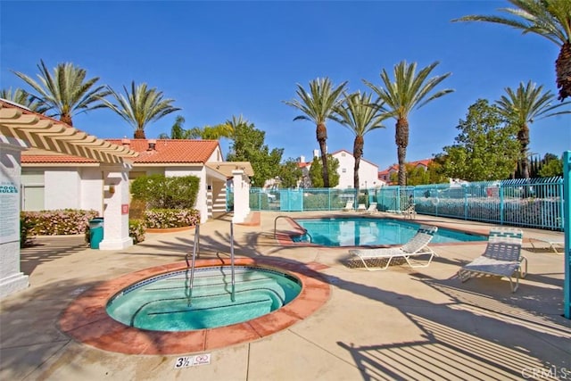 community pool with a community hot tub, fence, and a patio