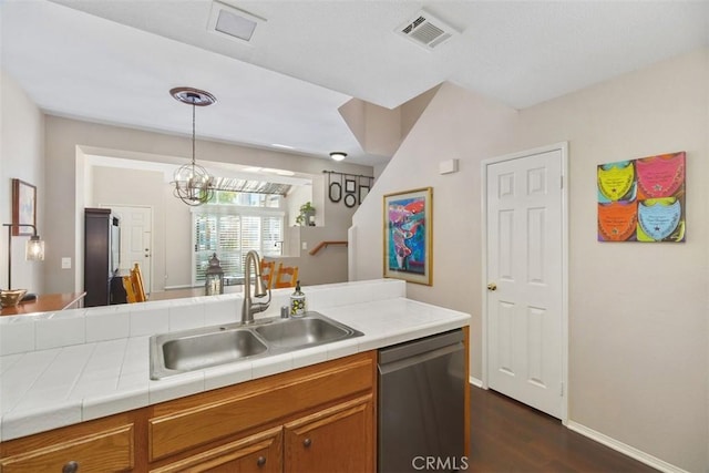 kitchen with dark wood-style floors, visible vents, brown cabinetry, a sink, and dishwasher