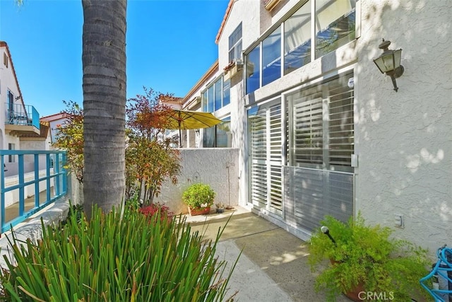 exterior space with fence and stucco siding