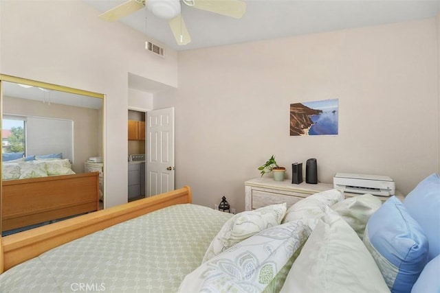 bedroom featuring lofted ceiling, visible vents, a ceiling fan, a closet, and washer / dryer