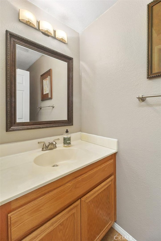 bathroom featuring vanity and baseboards