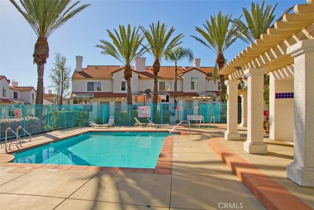 community pool with a residential view, fence, a pergola, and a patio