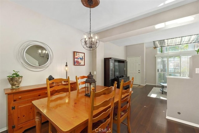 dining space featuring dark wood-style floors, a notable chandelier, and baseboards