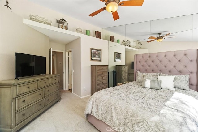 bedroom with lofted ceiling, baseboards, a ceiling fan, and light colored carpet