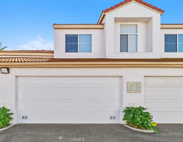 garage with aphalt driveway