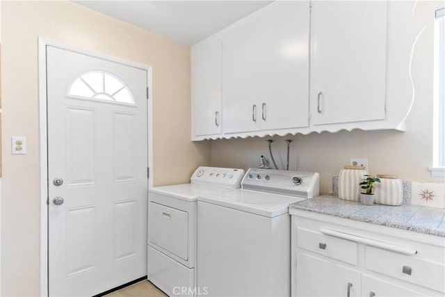 washroom with plenty of natural light, washing machine and dryer, and cabinet space