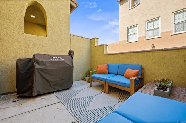 view of patio featuring an outdoor hangout area, area for grilling, and fence