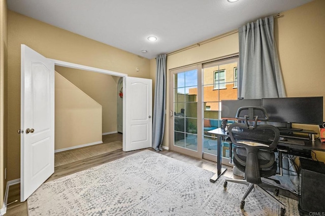 office space with baseboards and wood finished floors