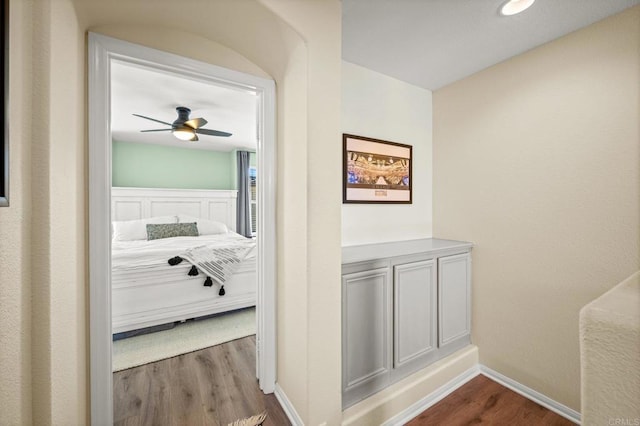 corridor featuring dark wood finished floors