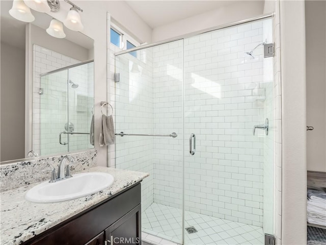 full bathroom featuring a stall shower and vanity