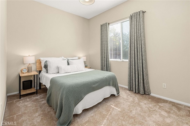 bedroom featuring carpet and baseboards