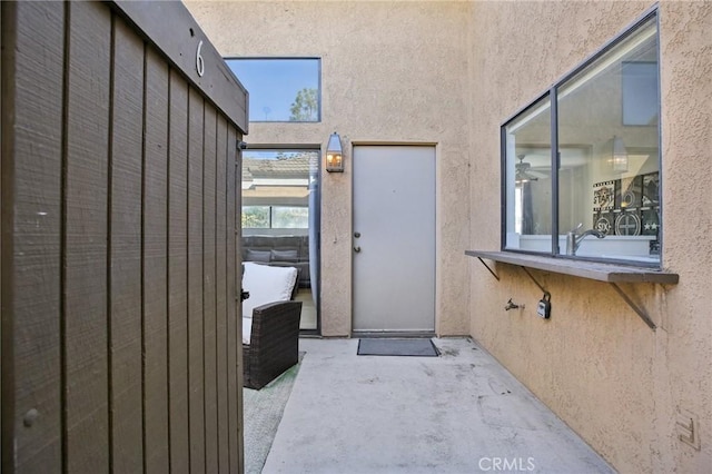 doorway to property with a patio and stucco siding