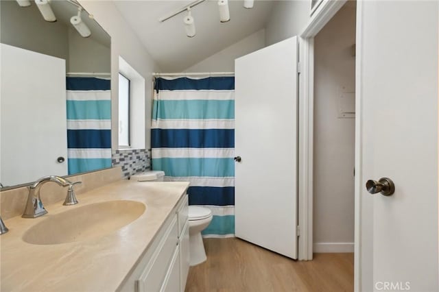 full bathroom with toilet, vaulted ceiling, vanity, wood finished floors, and a shower with curtain