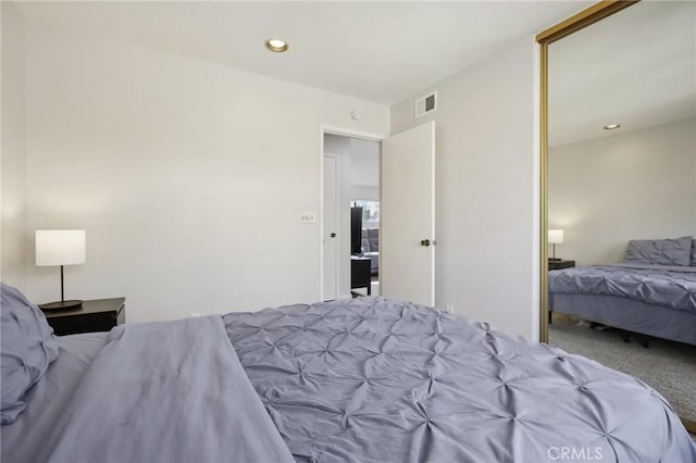 bedroom featuring carpet, visible vents, and recessed lighting