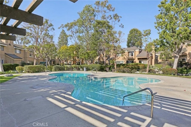 pool featuring a residential view and a patio