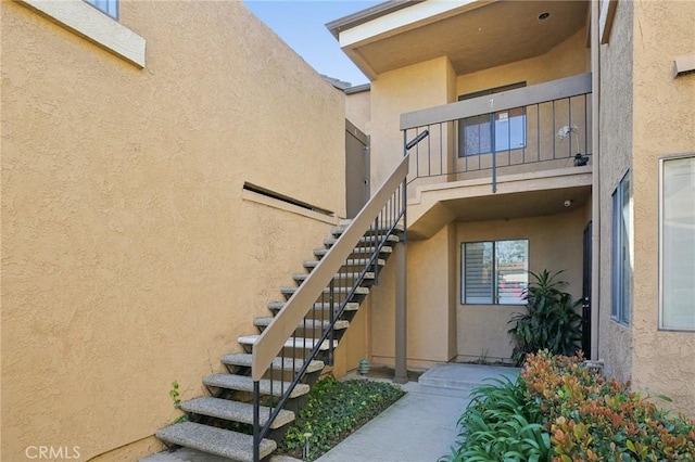 view of exterior entry featuring stucco siding