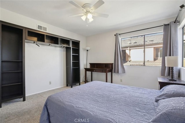 bedroom with baseboards, carpet floors, visible vents, and a ceiling fan