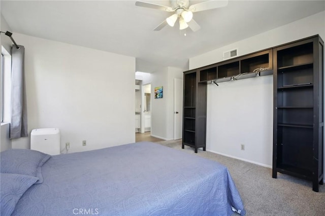 bedroom featuring ceiling fan, visible vents, and light colored carpet