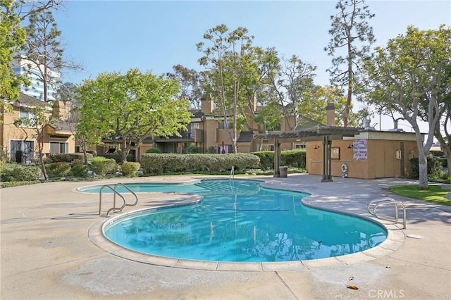 pool featuring a patio and a residential view