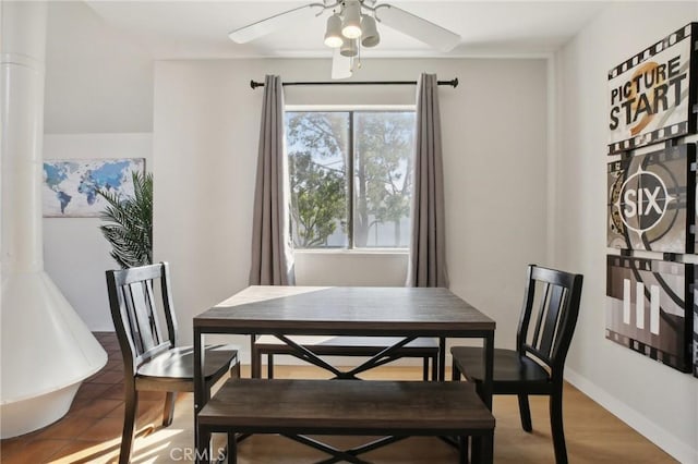 dining area featuring ceiling fan and tile patterned floors