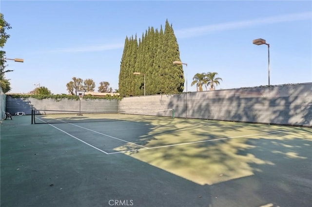 view of tennis court with fence