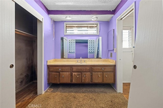 bathroom with a textured ceiling and vanity