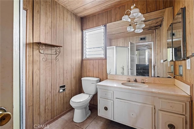 bathroom with vanity, tile patterned flooring, toilet, and wooden walls