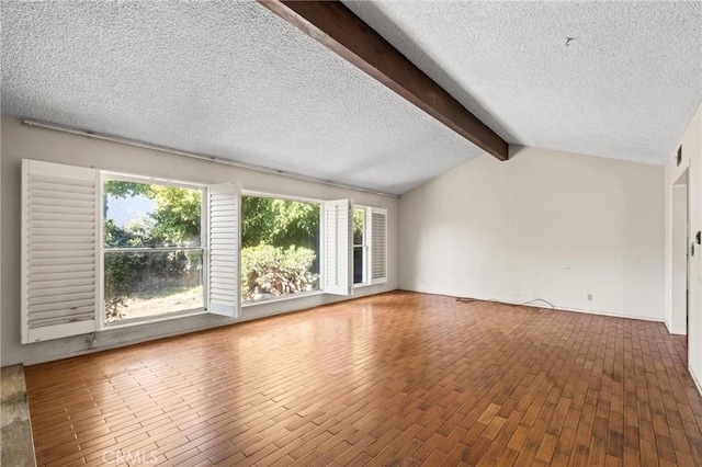 unfurnished living room featuring visible vents, lofted ceiling with beams, a textured ceiling, and wood finished floors