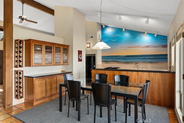 tiled dining room featuring lofted ceiling, ceiling fan, and visible vents