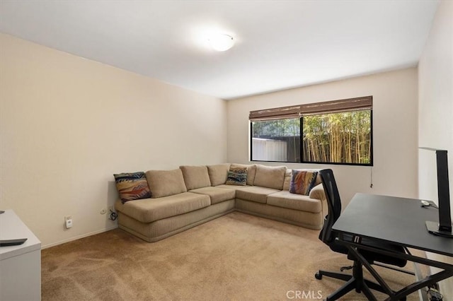 carpeted home office featuring baseboards