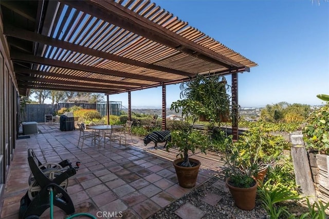 view of patio / terrace with outdoor dining space, fence, and a pergola