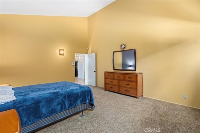 bedroom featuring high vaulted ceiling and carpet