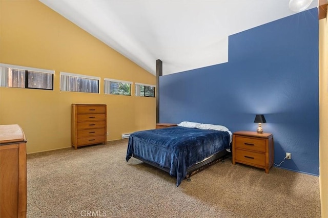 bedroom with carpet floors and lofted ceiling