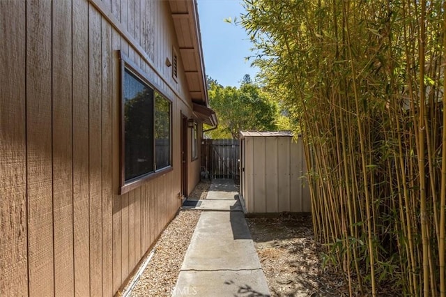 view of home's exterior featuring a fenced backyard, a shed, and an outdoor structure