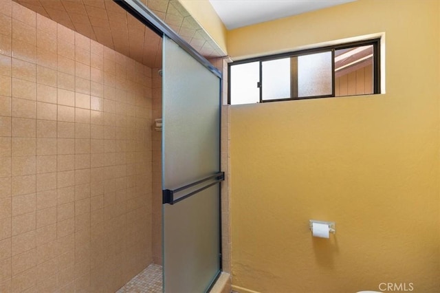 bathroom with tiled shower