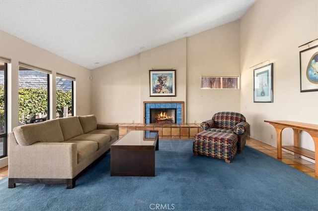 living area featuring lofted ceiling, a fireplace, carpet, and tile patterned floors