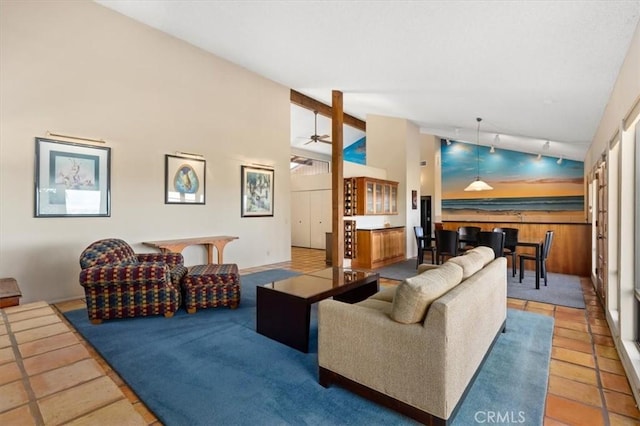 living room with ceiling fan, high vaulted ceiling, and tile patterned flooring