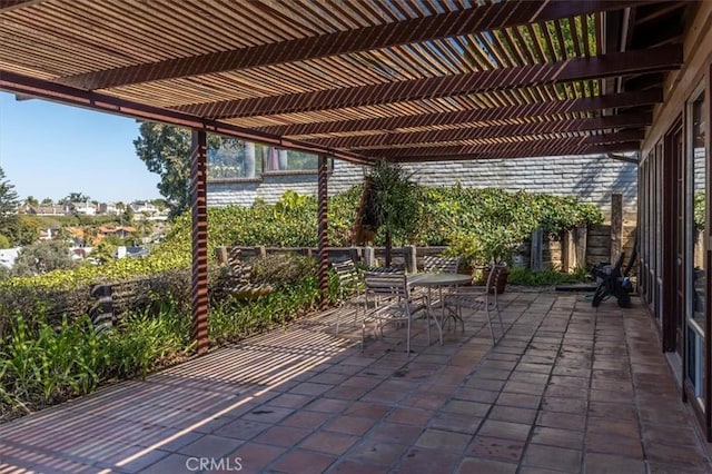 view of patio featuring outdoor dining area and a pergola