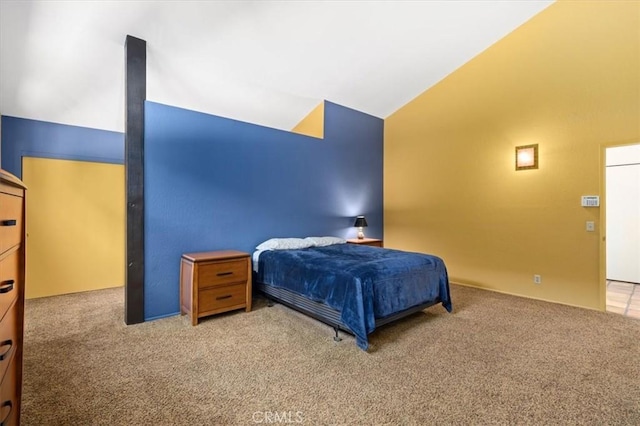 carpeted bedroom with lofted ceiling