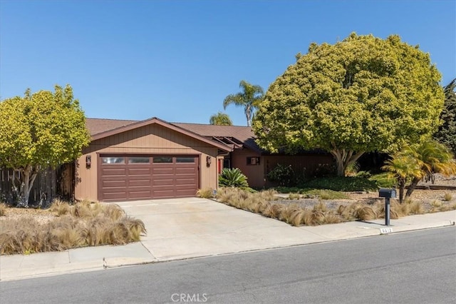 ranch-style home with a garage and driveway