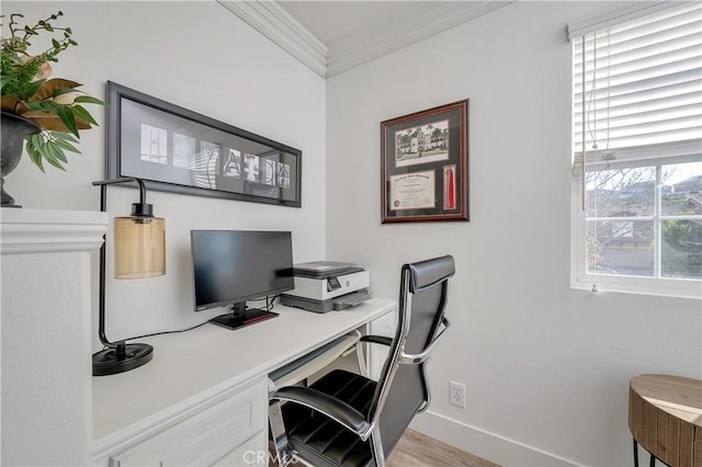 office space featuring light wood-style floors, baseboards, and crown molding
