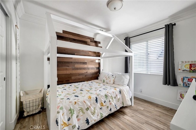 bedroom with baseboards and wood finished floors