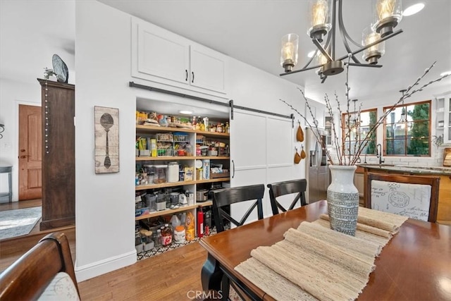 dining space with a chandelier and wood finished floors