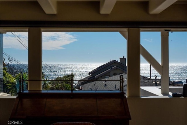 interior space featuring a water view and multiple windows