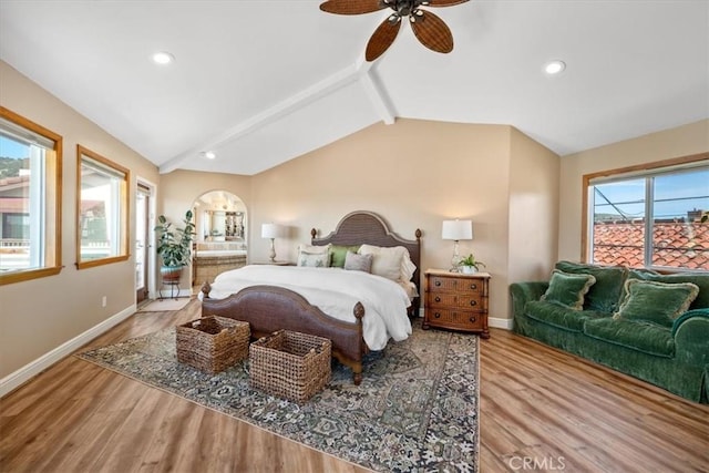 bedroom with vaulted ceiling with beams, wood finished floors, and arched walkways