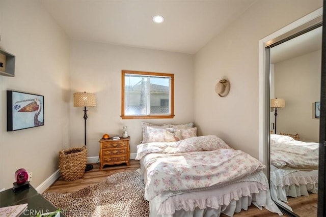 bedroom featuring recessed lighting, wood finished floors, and baseboards