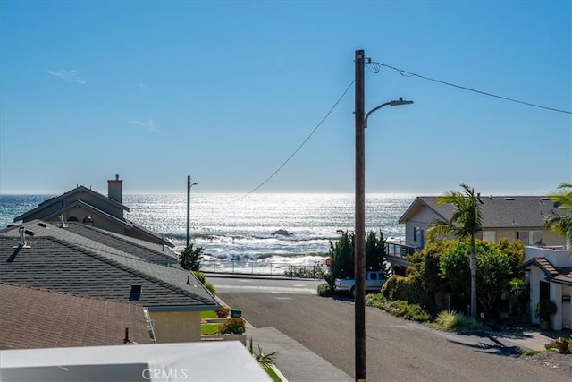 view of street featuring a water view and street lights