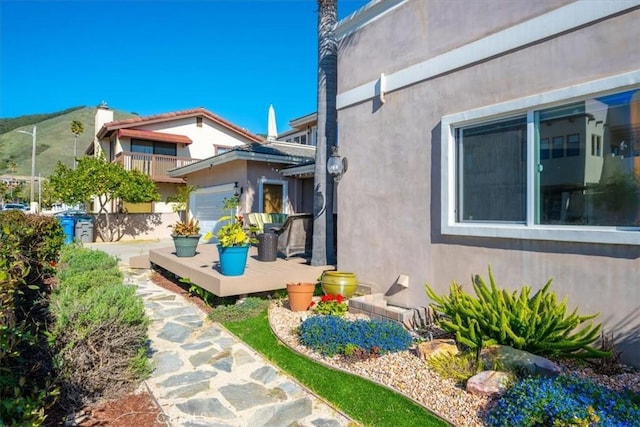 view of property exterior with a deck and stucco siding