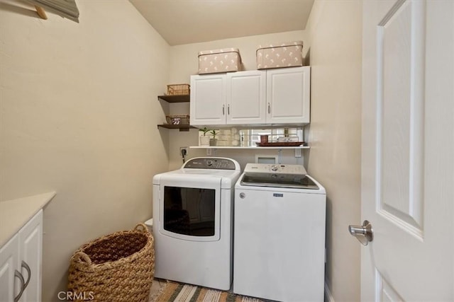 laundry area featuring cabinet space and washing machine and clothes dryer